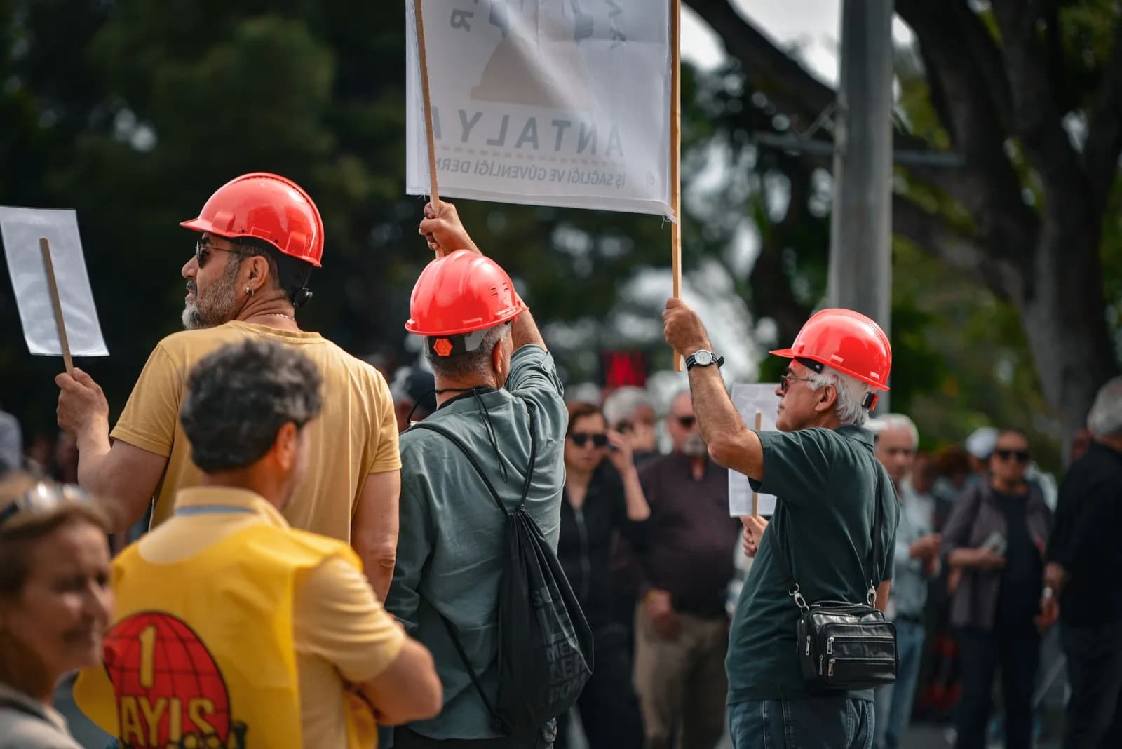 Trabalhadores em manifestação com capacetes vermelhos durante greve